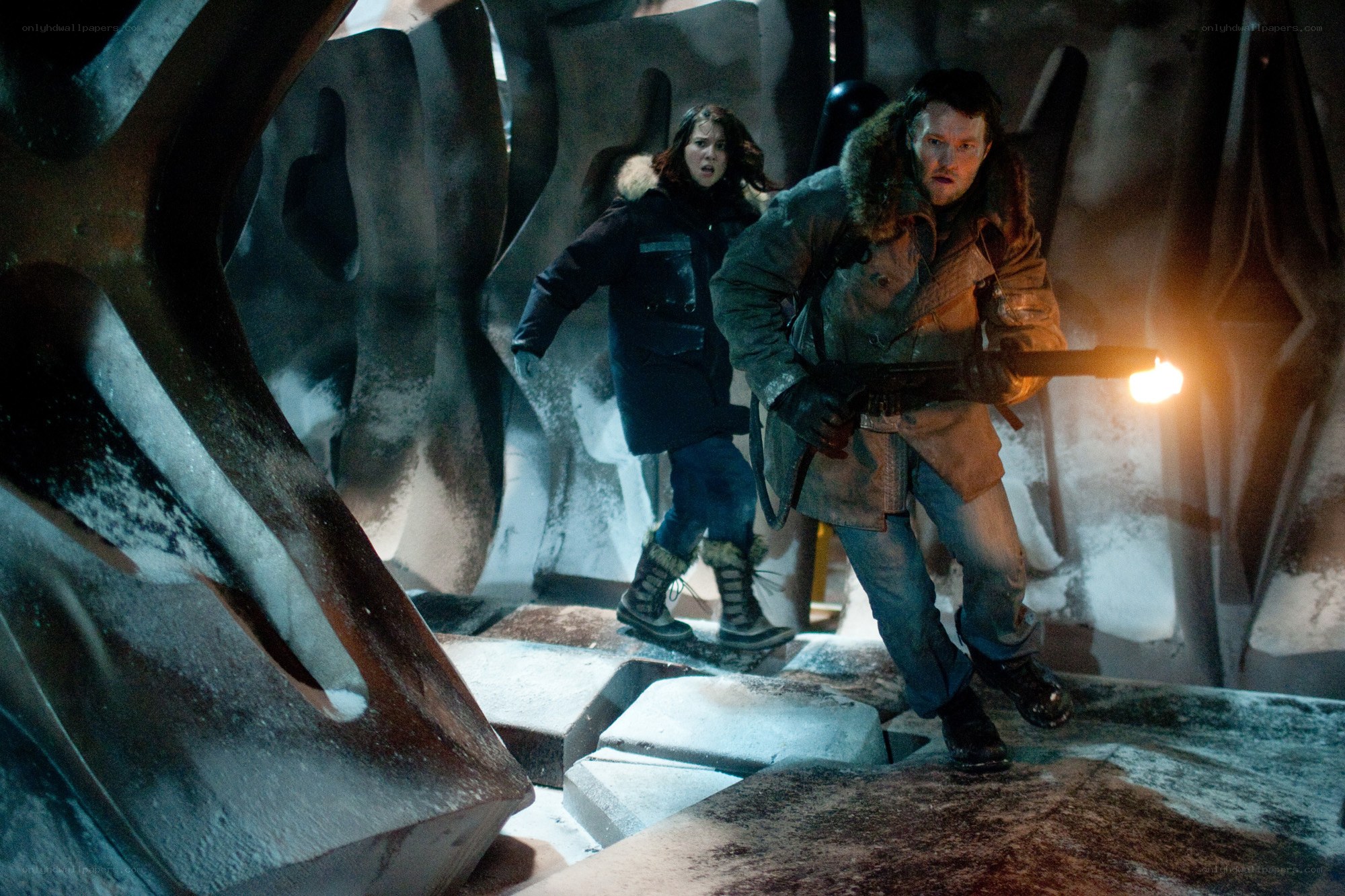 People in icy cave with flashlight