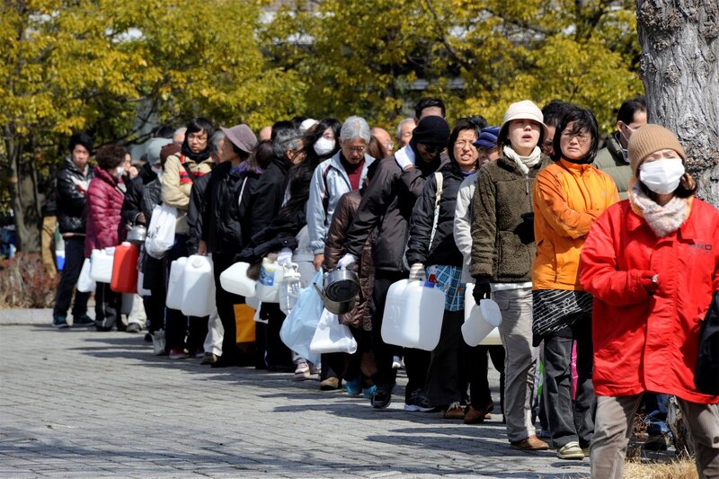 People in Line with Containers
