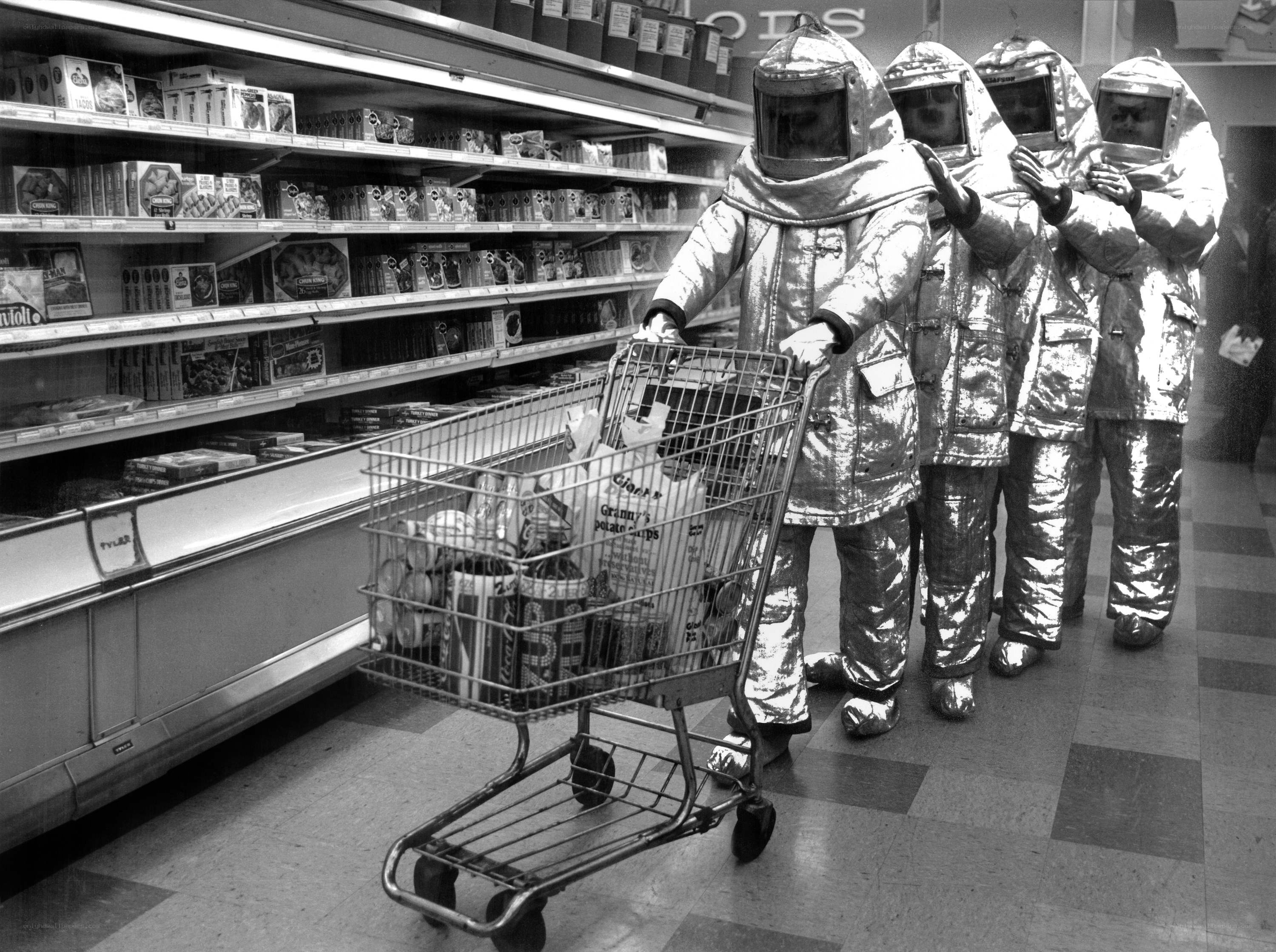 People in protective suits shopping