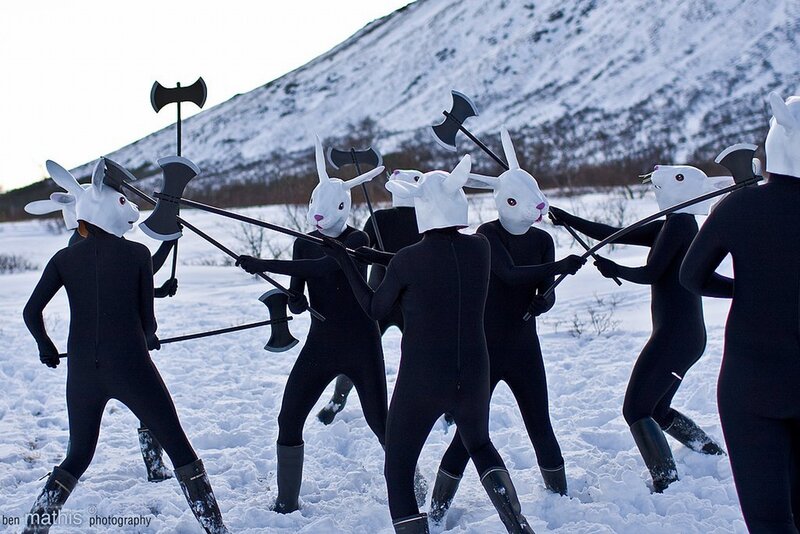 People in rabbit costumes with axes