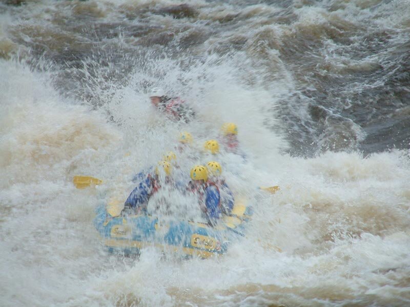 People in Raft on Rapids — Blue
