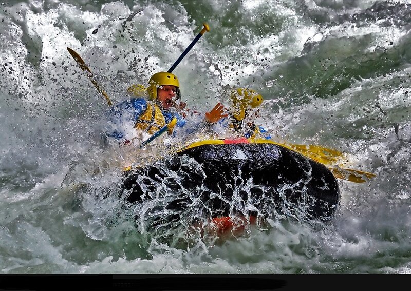 People in Raft on Rapids