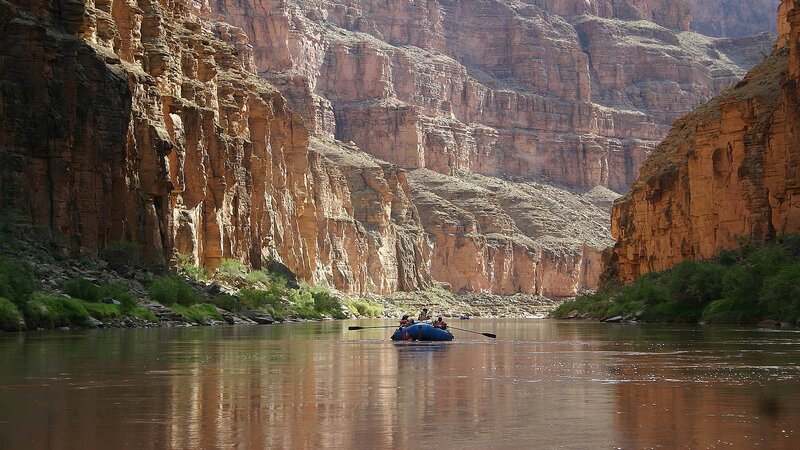People in Raft on River — Brown, Serene