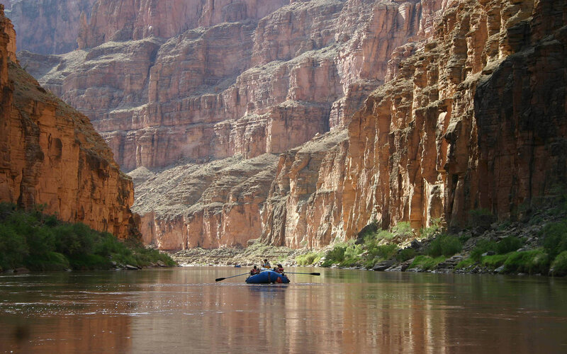 People in Raft on River — Brown