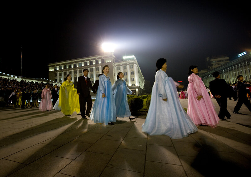 People in traditional clothing at night