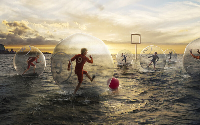People in water balls on beach