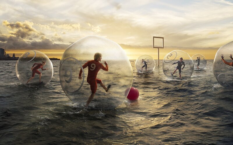 People in water balls on beach