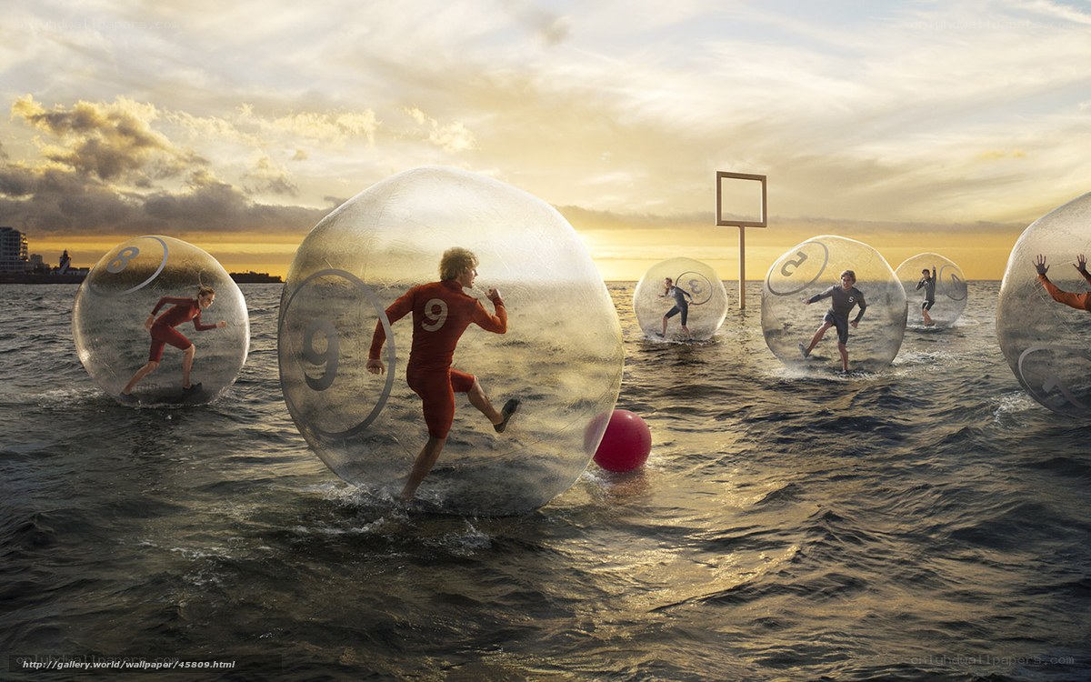 People in water balls on beach