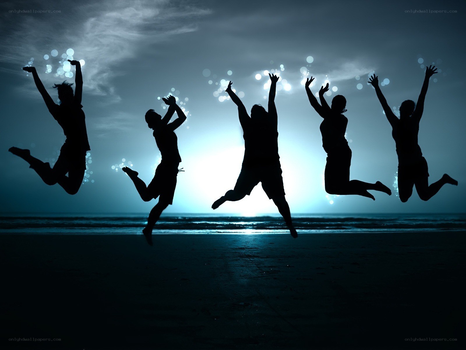People jumping on the beach
