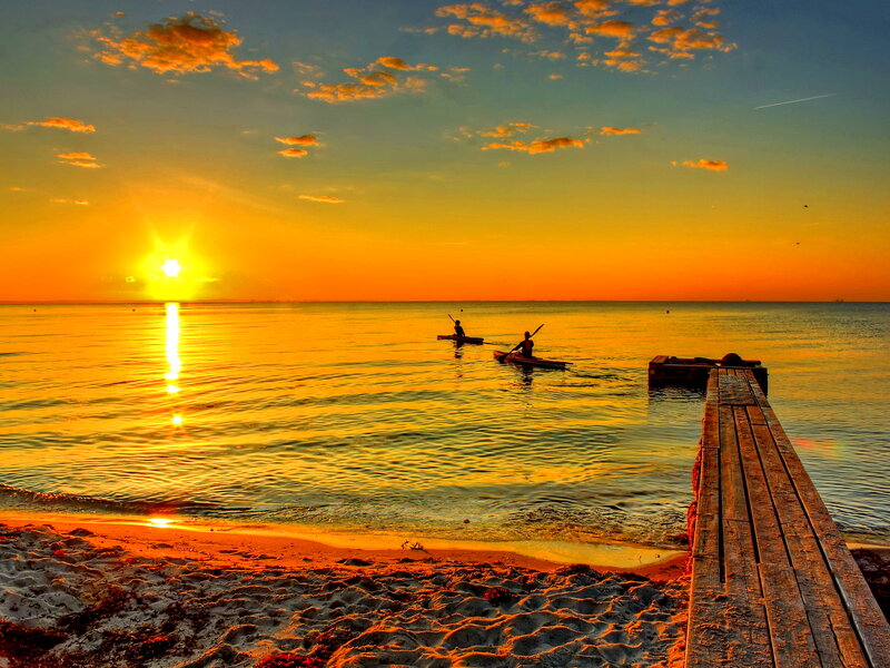 People Kayaking at Sunset