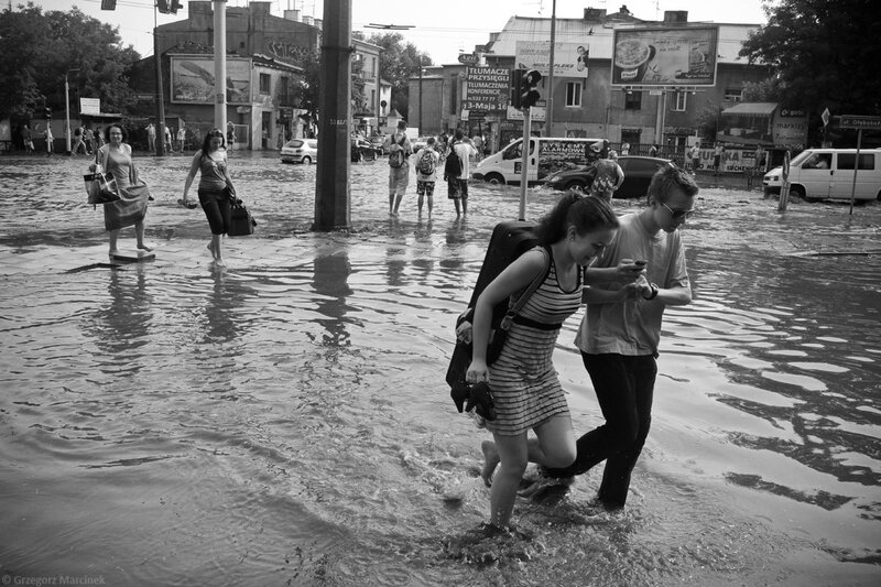 People navigating flooded street