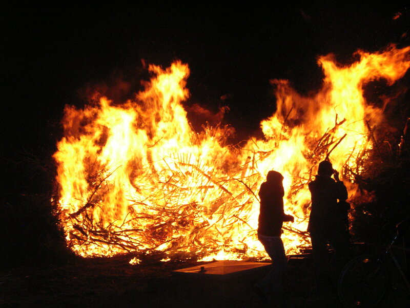 People near a bonfire at night