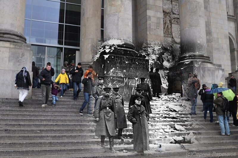 People near damaged monument