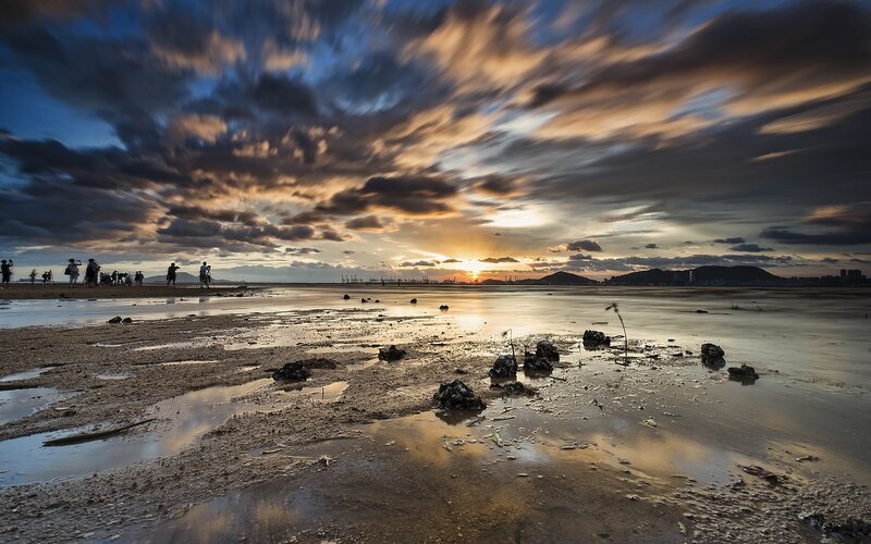 People on a Beach at Sunset — Blue