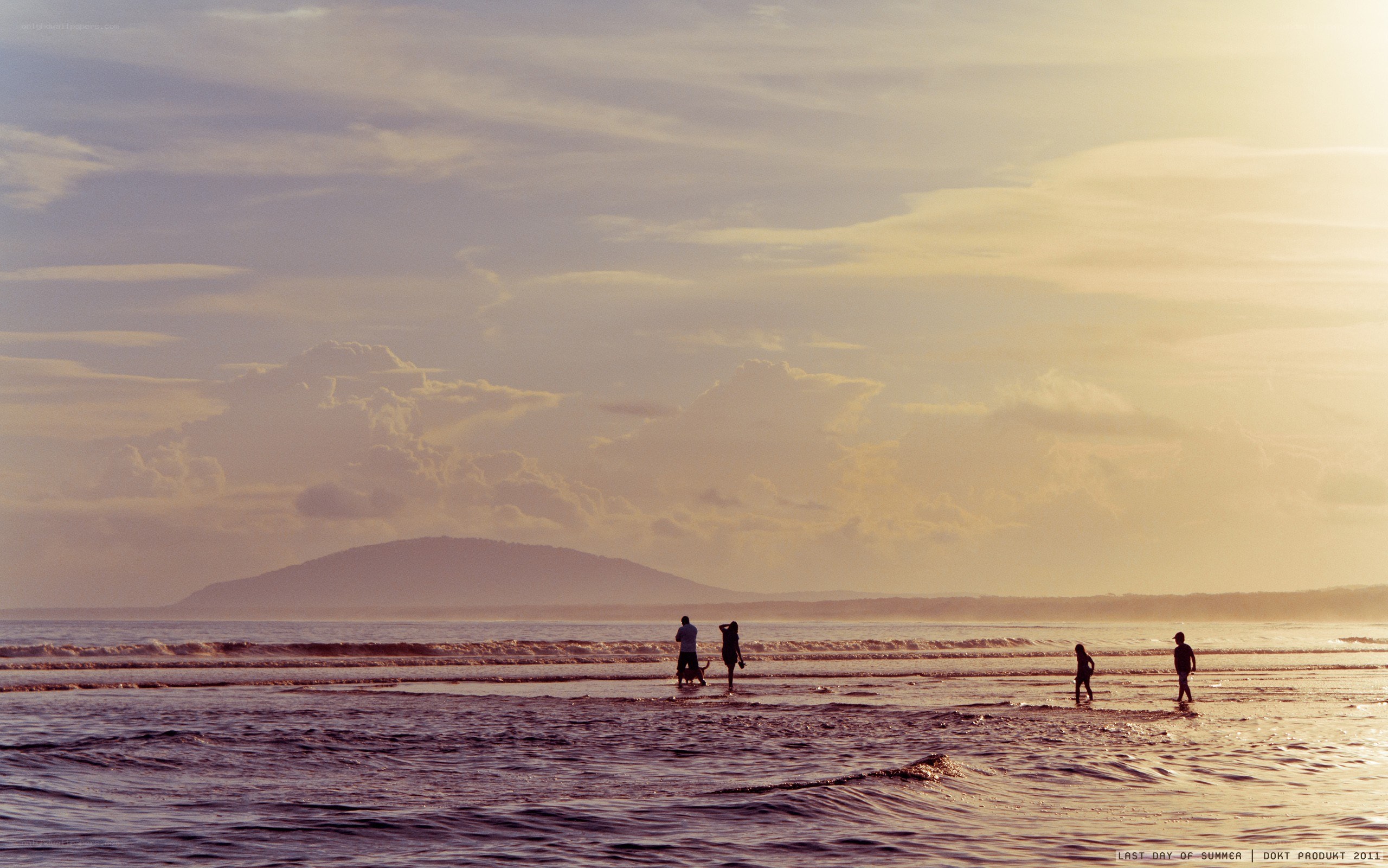 People on a beach at sunset