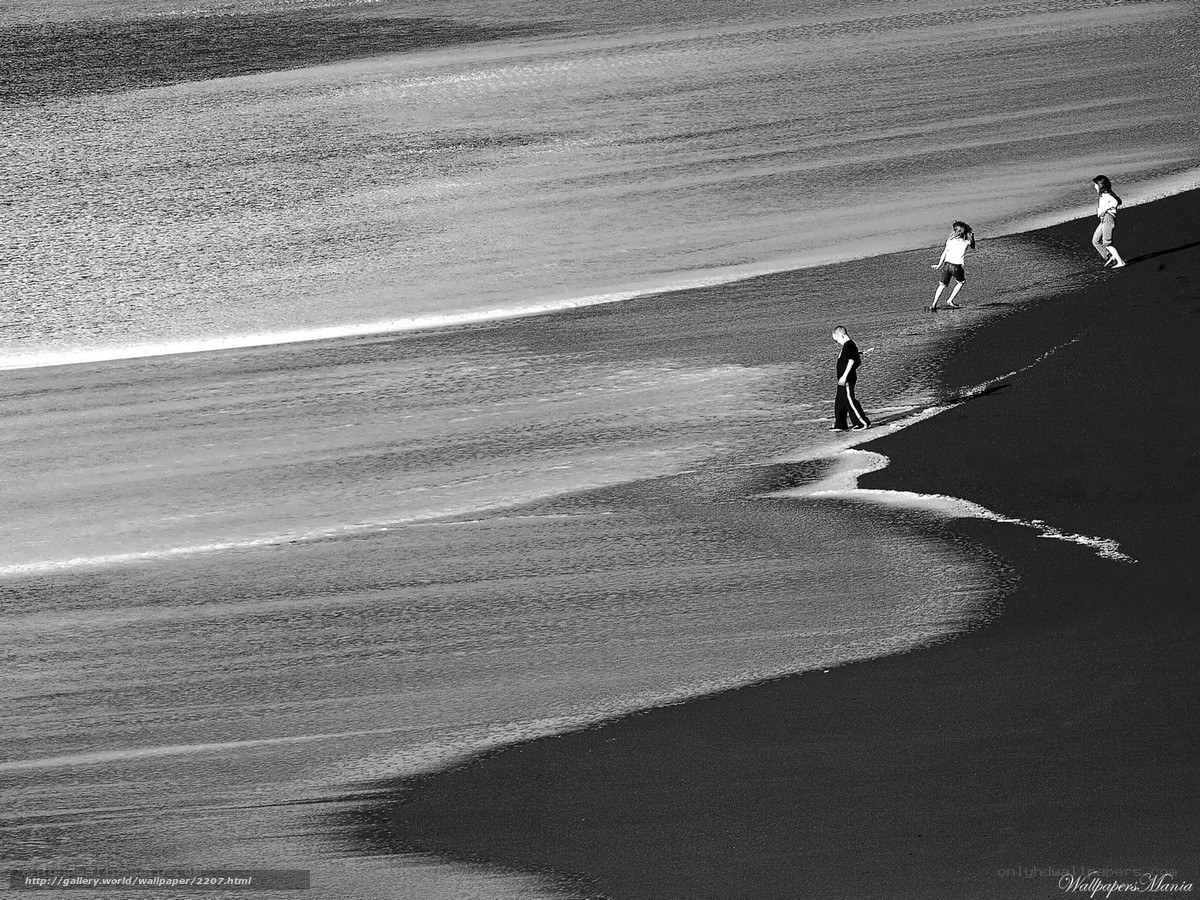 People on a black sand beach