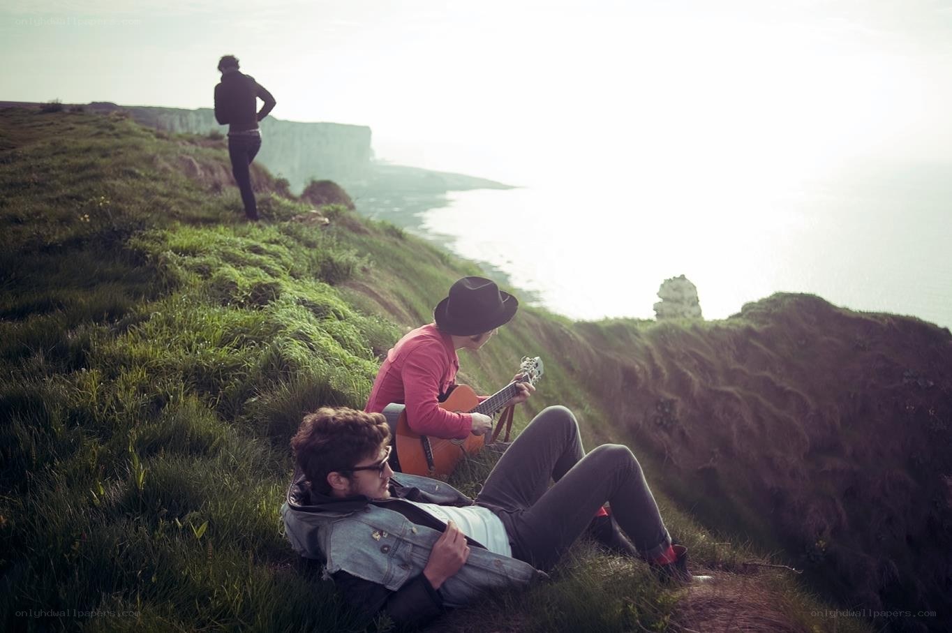 People on a grassy cliff