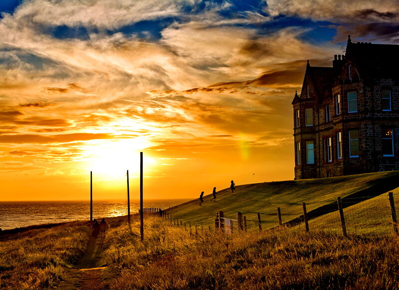 People on a Hill at Sunset — Orange