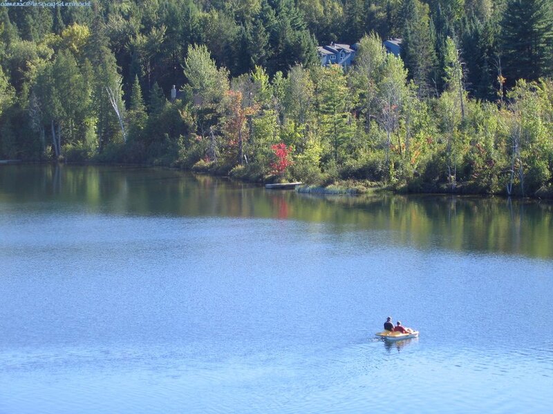 People on a paddleboat at a lake