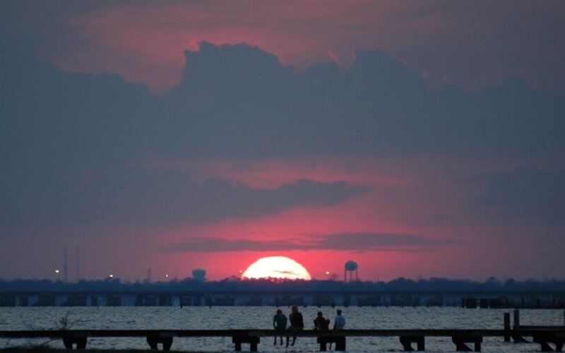 People on a Pier at Sunset — Purple