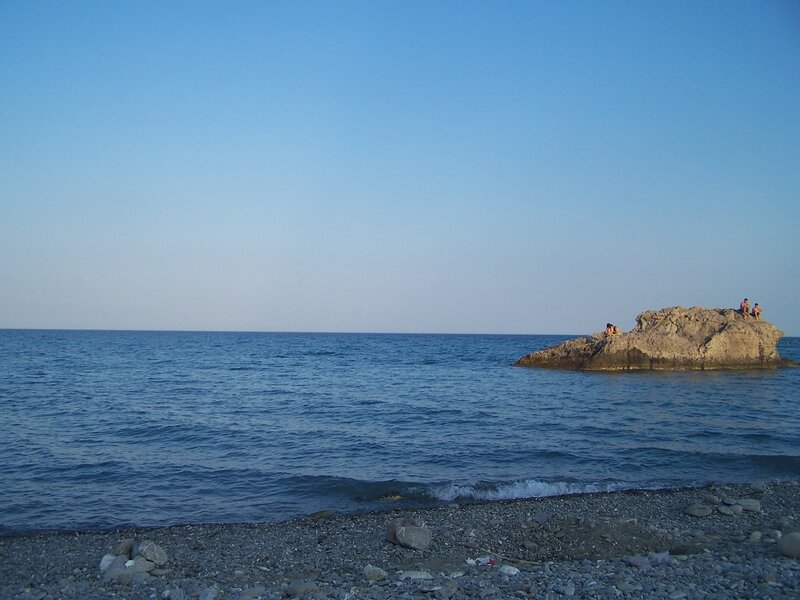 People on a rock by the sea