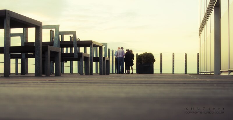 People on a rooftop at sunset