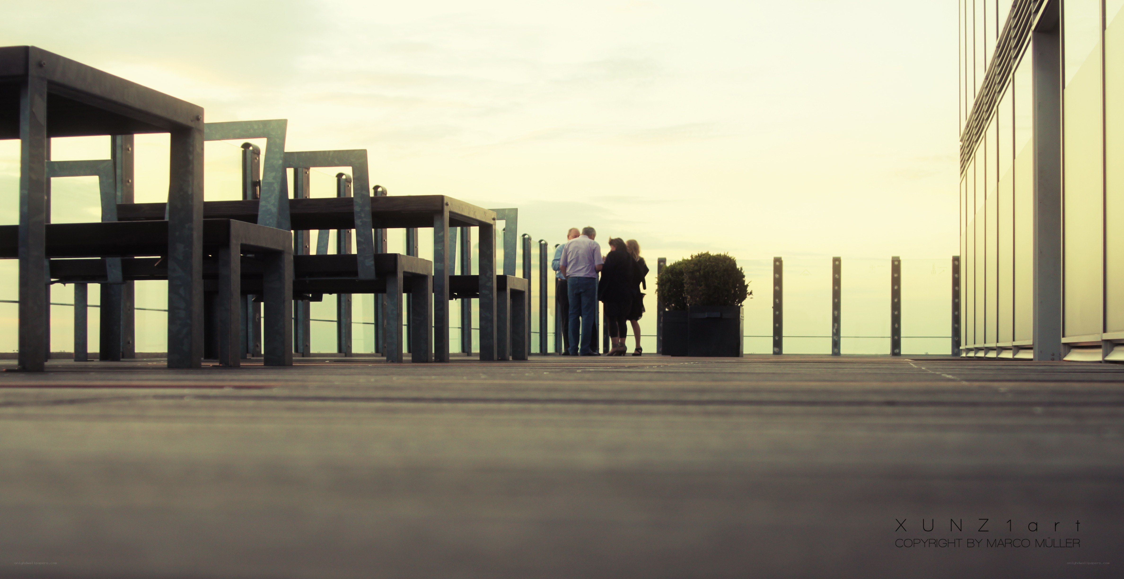 People on a rooftop at sunset