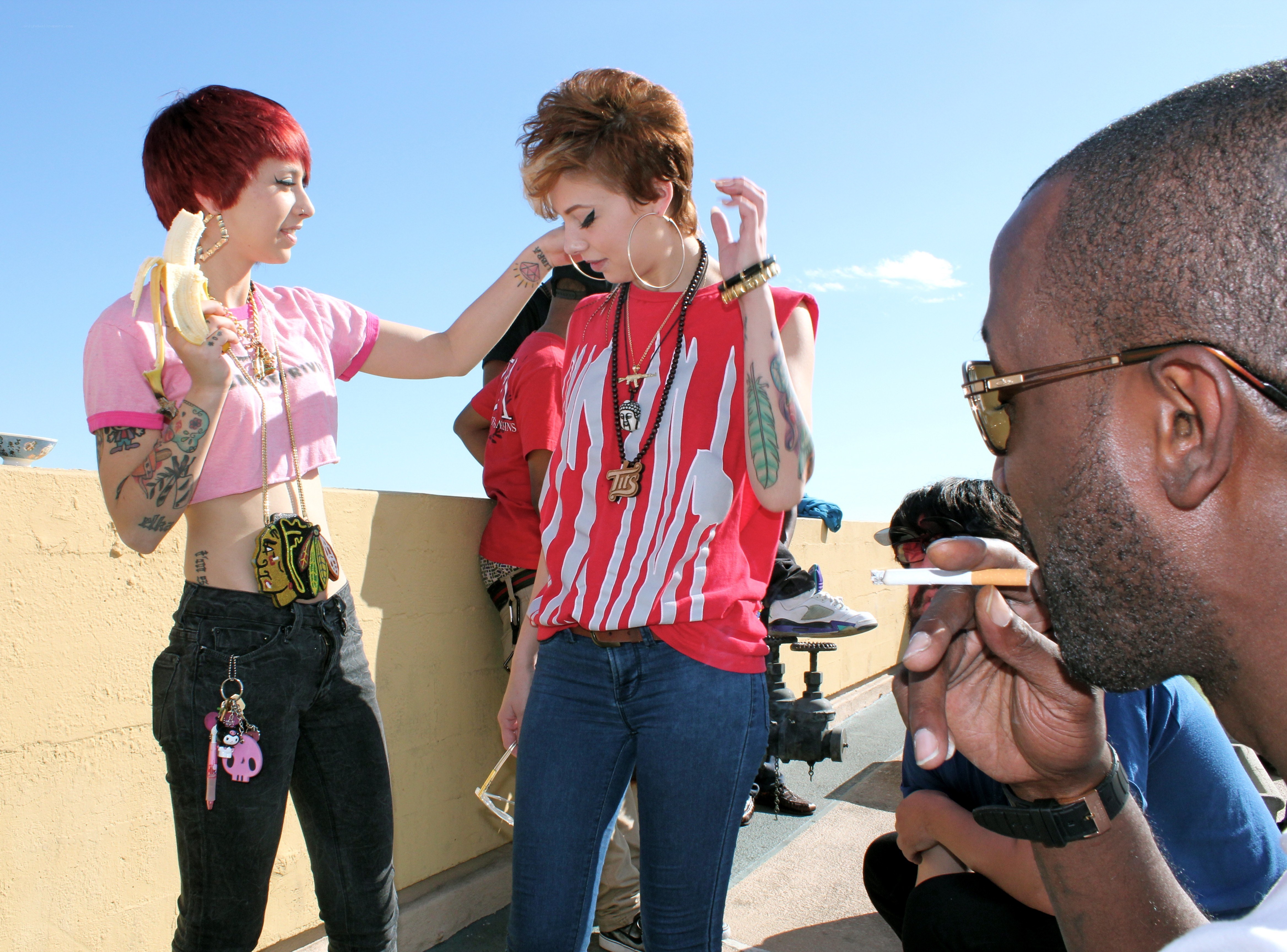 People on a rooftop with tattoos