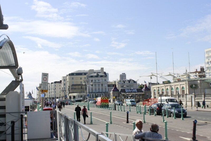 People on a Seaside Promenade — Blue