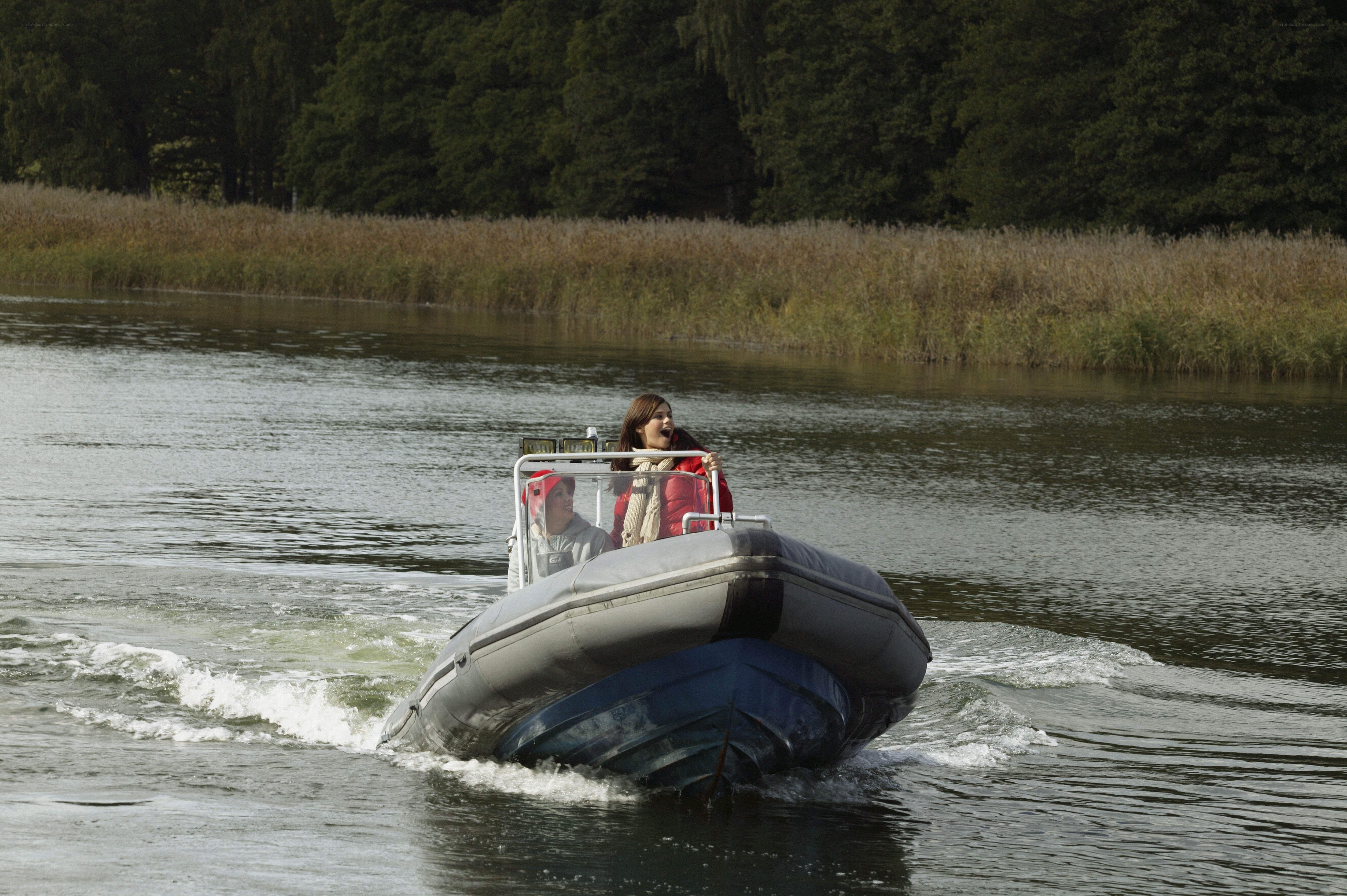People on a speedboat on a river