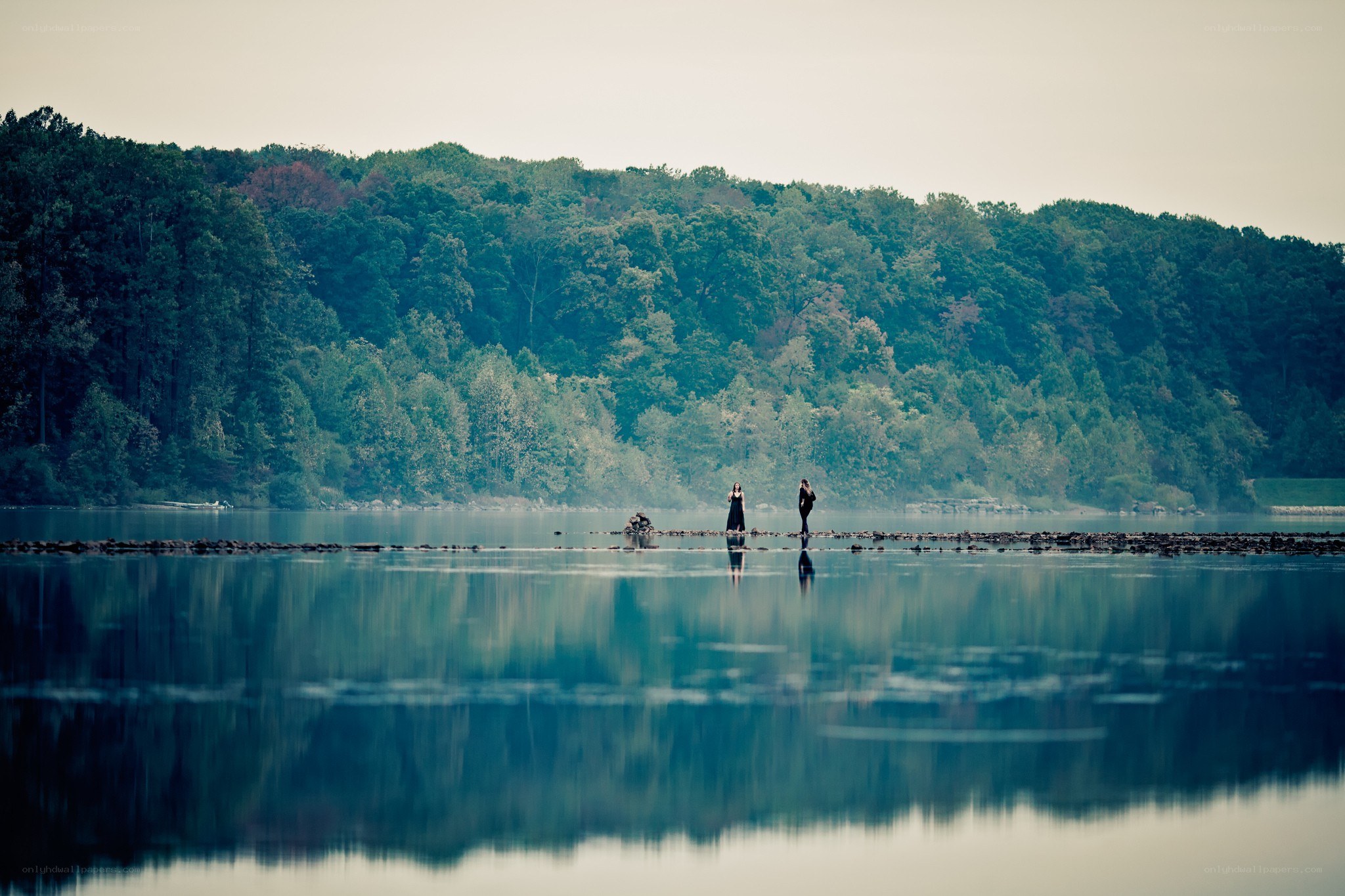People on a stone path by the lake