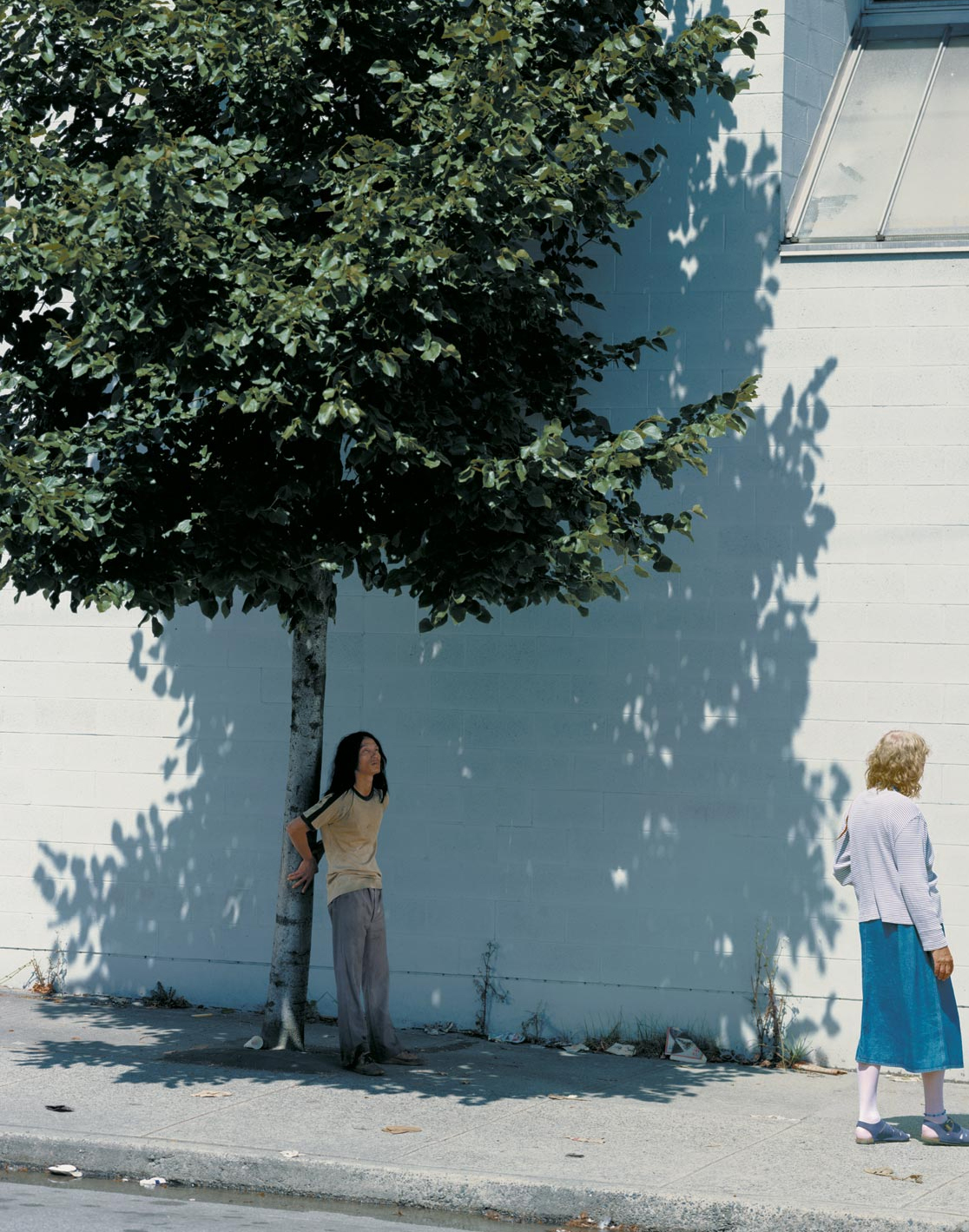 People on a sunny sidewalk