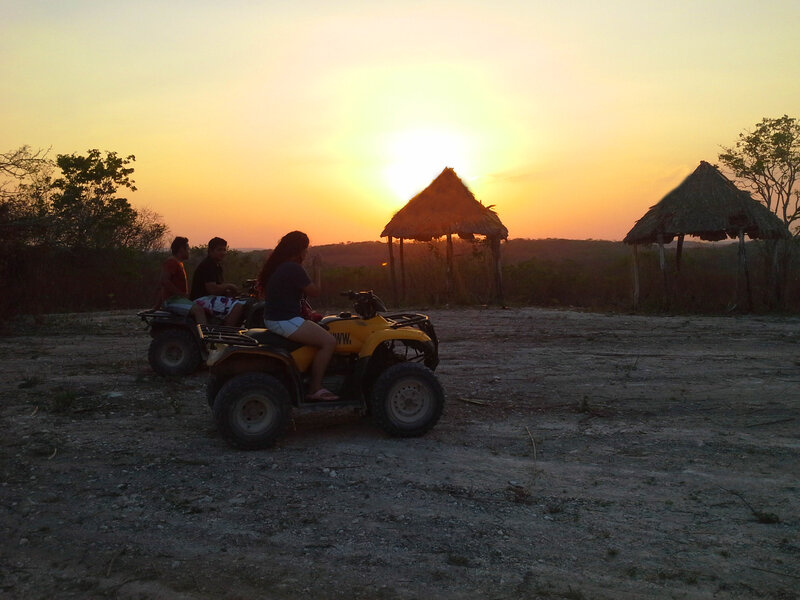 People on ATVs at Sunset