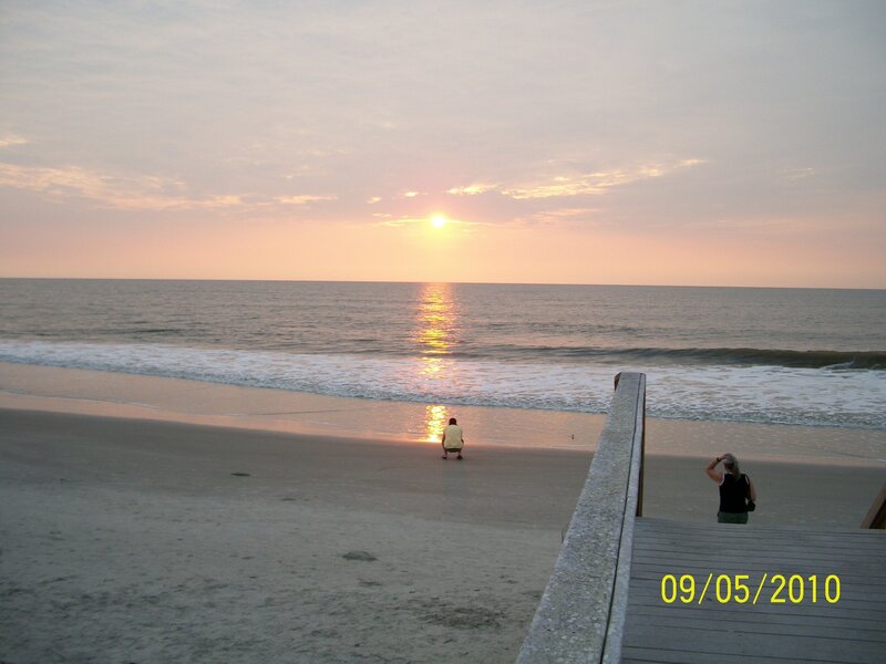 People on Beach at Sunset — Orange