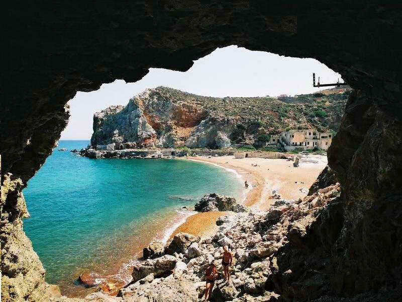 People on Beach Through Cave