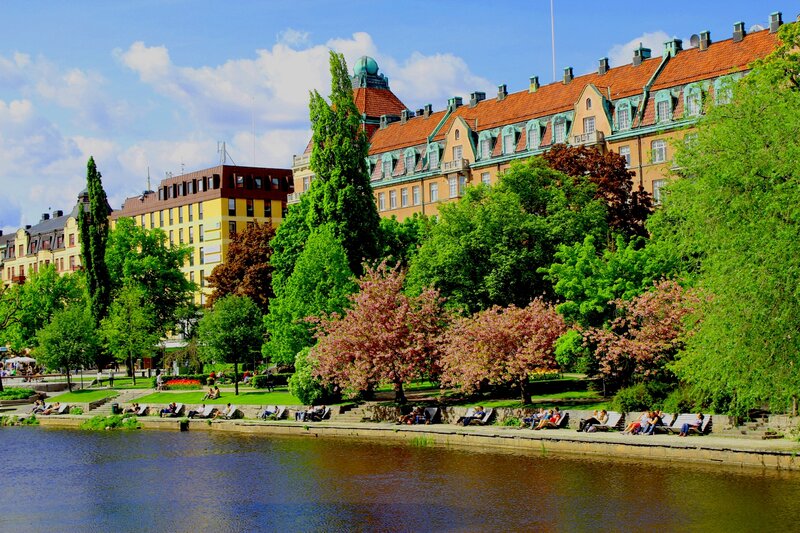 People on Benches by River
