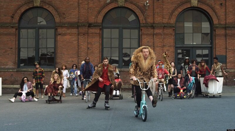 People on bikes in front of brick building
