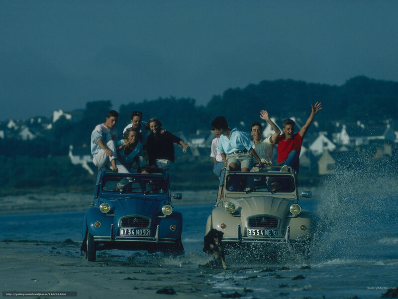People on cars at the beach
