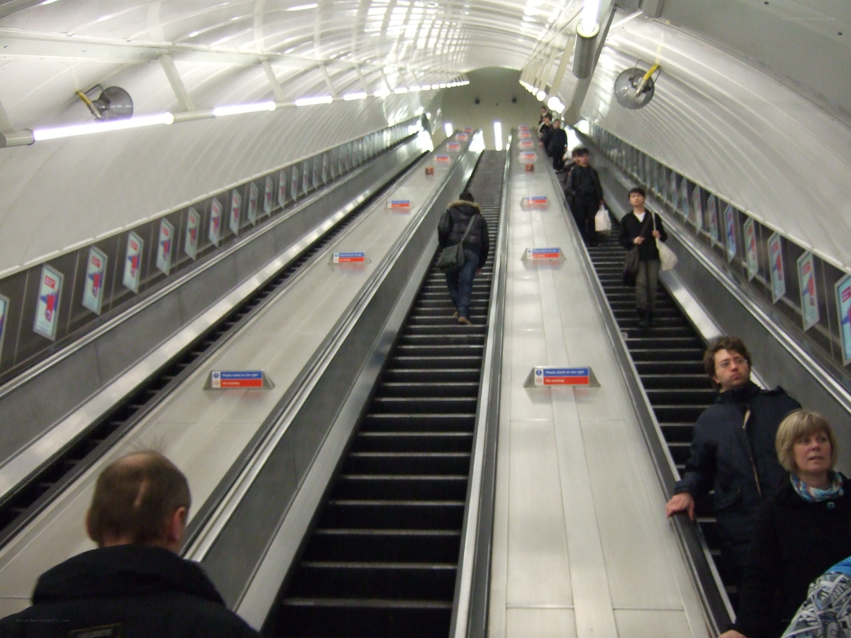 People on escalators in subway