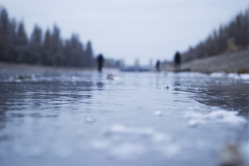 People on Frozen River — Blue