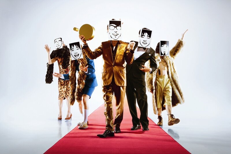 people on red carpet with masks
