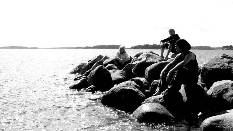 People on rocks by the water