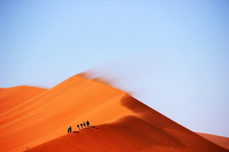 People on Sand Dune — Orange, Serene