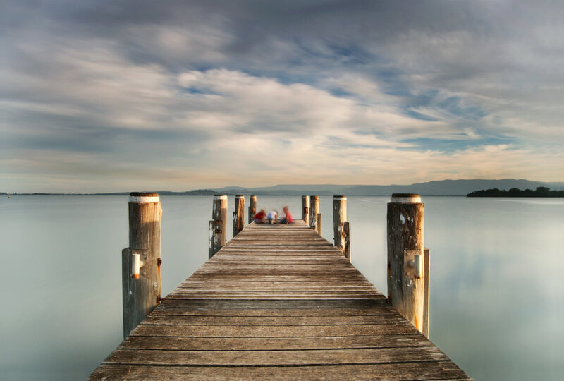 People on Wooden Pier — Blue