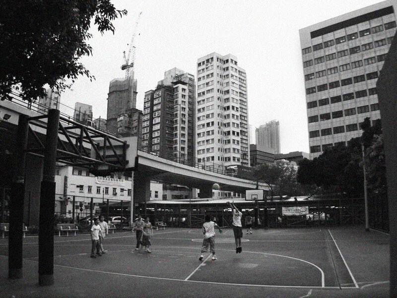 People playing basketball in city