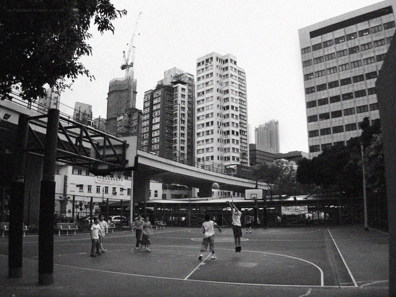 People playing basketball in city