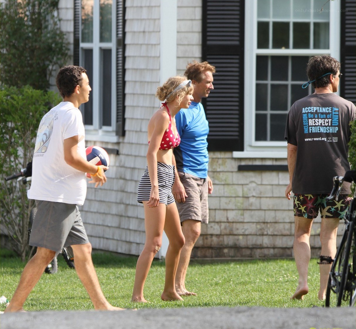 People playing volleyball in yard