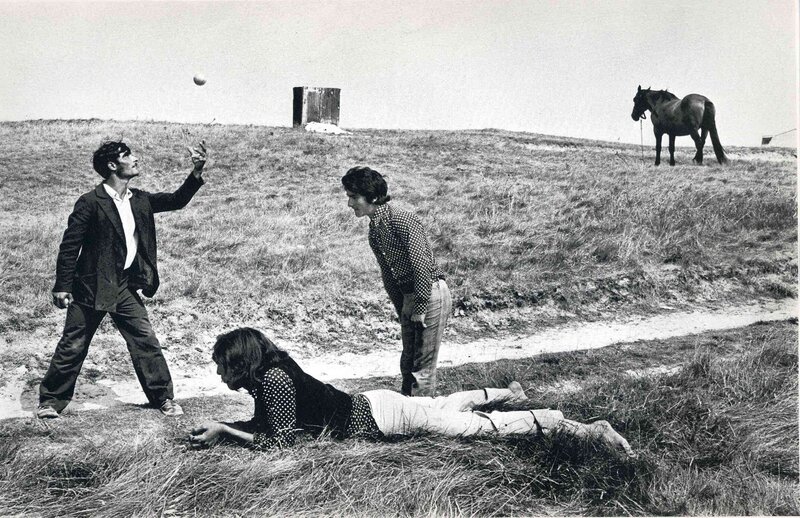 People playing with a ball in a field