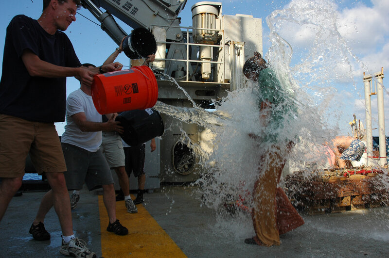 People pouring water on a person