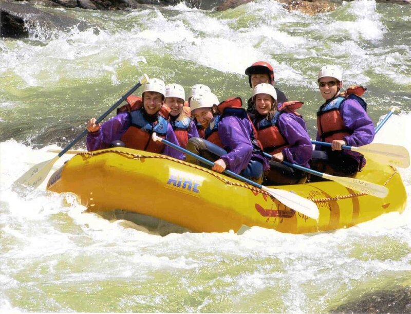 People Rafting on River